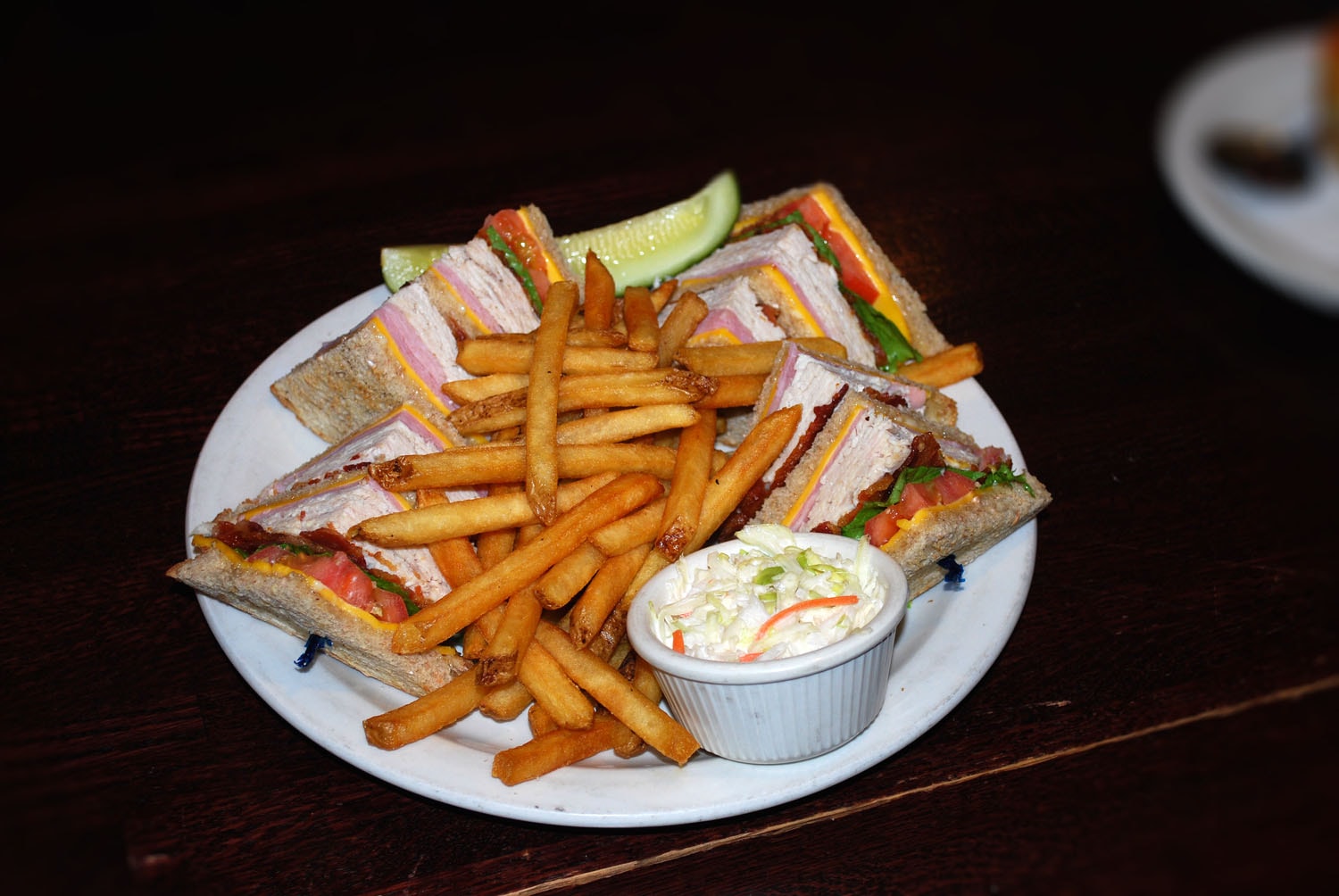 A plate of club sandwich and fries